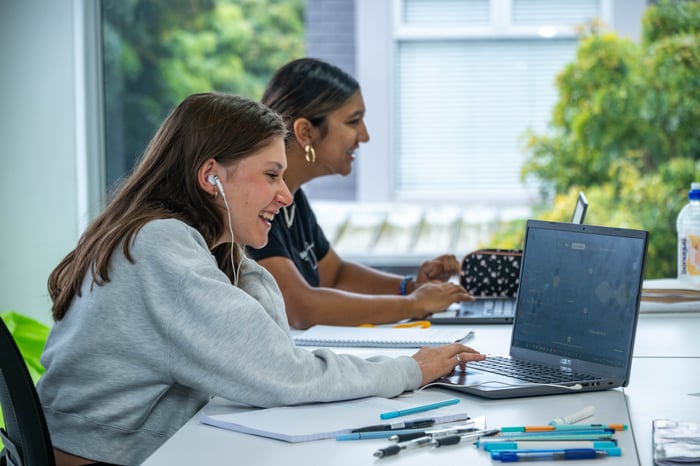 Two girls learning on computers